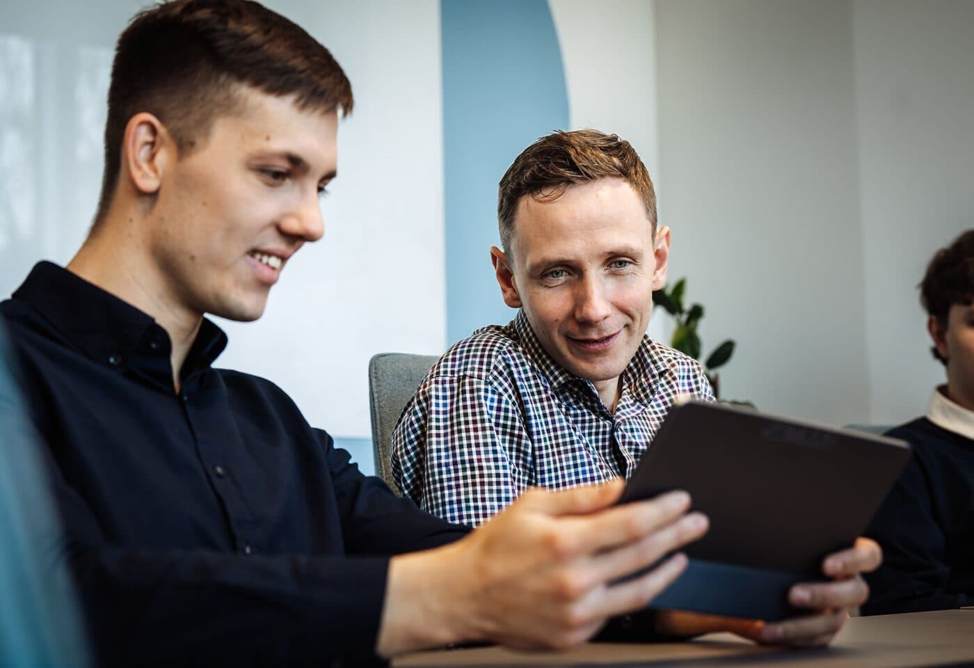 An Openora.ai engineer reviewing a change on a tablet